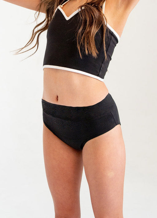 Girl wearing period and incontinence liner dance briefs and a sports bra shirt with adjustable straps